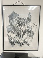 Full view of framed Escher print in black metal frame