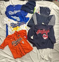 All six apparel items laid out showing fronts and logos
