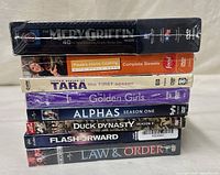 Stacked view of all eight sealed DVD sets showing spines
