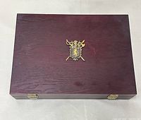 Closed wood presentation box with crest emblem