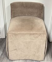 Full front view of grey velour armless chair