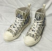 Full view of both sneakers angled left showing uppers, laces, soles