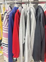 Seven hoodies on rack showing colours and brands