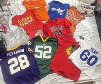 Full layout of jerseys and tees showing team graphics and numbers