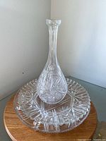 Decanter standing on footed plate showing overall design