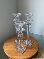 Three Mikasa King's Court crystal candlesticks on wooden stand