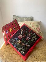 All four pillows grouped together showing designs