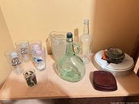 Full lot showing glasses, pitcher, jug, bottle, coasters, ashtray