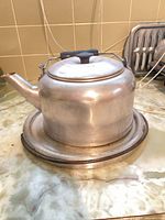 Kettle with lid on stand, side view