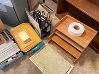 Group view showing wooden organizer, envelopes, sticky notes, power strip, desk mat