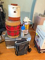 Front view of stacked items showing cooler branding and surrounding items