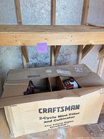Closed cardboard box showing Craftsman 2-Cycle Mini-Tiller and Cultivator branding