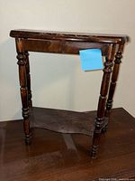 Oblique view of entire end table showing top, legs, and shelf