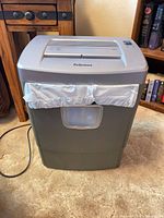 Front view of Fellowes DM65C shredder showing bin and clear window