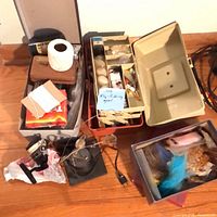 Group shot of tackle boxes, reel, fly box, fly-tying materials