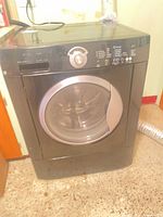 Full exterior view of black Frigidaire front-load washer