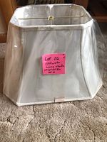 Front view of lampshade wrapped in plastic showing overall shape and size sticker