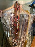 Assorted neckties on hanger, floral and striped visible