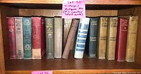 Full shelf view showing approximately 17 vintage books