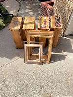 Four crates standing upright with stacked picture frames