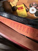 Close-up of belts, polish tins and brush