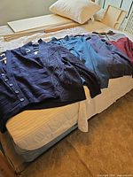 All garments laid out on bed showing colours and types