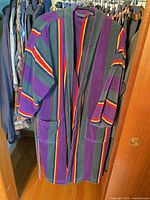 Full view of multicolor striped cotton terry men's bathrobe on hanger