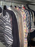 Closet rod with multiple men’s shirts showing variety of styles and colours