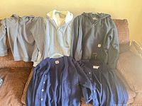 All five garments laid out on couch