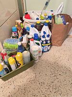 Group shot of all cleaning supplies in caddies, basket and bag