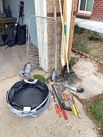 lot overview with cart, rakes, bag, edging and hand tools