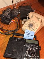 Group shot shows rotary phone, Retekess radio, remotes, KCPI converter, RCA cables