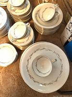Stacks of saucers, cups, plates showing Graywood pattern