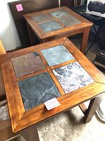 Two matching wood end tables with slate tile tops