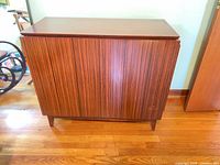 Closed wood console showing exterior veneer and legs