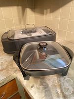 Both electric appliances with lids visible on countertop