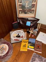 Grouping of books, plates, rosary, crucifix, figurines and pouch