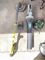 All items laid out: Ryobi trimmer, EGO blower, EGO battery, Ryobi charger
