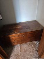 Full view of wooden hope chest in closet