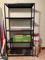 Full frontal view of five-shelf black metal unit