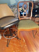 Wood dining chair and metal bar stool side by side on wood floor