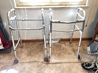 Two aluminum front-wheel walkers side by side