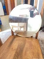 Round mirror on chair showing frame and glass