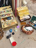 Overview of tackle boxes, leather bag, small boxes and loose tackle on ground