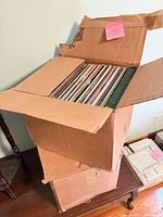 Two stacked cardboard boxes filled with vinyl records
