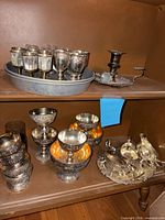 Group of goblets, sauce boats on tray, coupes, cordial cups, chamberstick