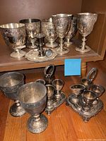 Full lot showing goblets, cruet stands and chamberstick