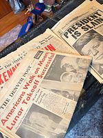 Assorted newspapers with JFK assassination and Apollo 11 moon landing headlines
