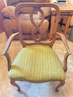 Full front view of Queen Anne armchair showing wood frame and green seat