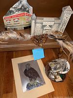 Overall view showing both decanters, feather band, eagle print, dish with pins